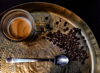 turkish strong coffee in a glass from a cafe. coffe beans