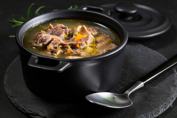 Chicken gizzards stewed with carrot in sauce.