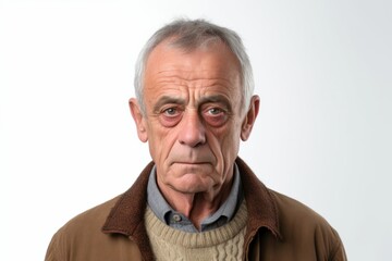 Obraz premium Medium shot portrait photography of a man in his 60s with furrowed brows and a tense expression due to hypertension wearing a chic cardigan against a white background 
