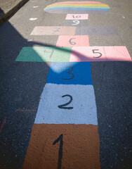 Colorful hopscotch game on asphalt