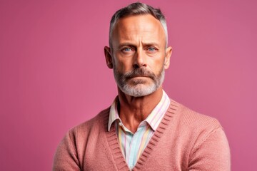 Obraz premium Close-up portrait photography of a man in his 40s with furrowed brows and a tense expression due to hypertension wearing a chic cardigan against a pastel or soft colors background 