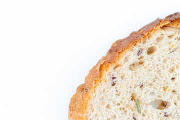Detail of piece of slice of gluten-free seed bread, on top of a white background. Alveoli, seeds...