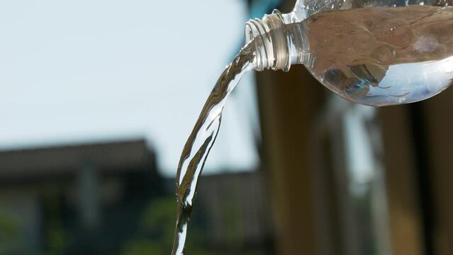 Water being poured from the bottle in slow motion