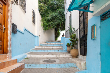 Narrow alley with stairs and houses painted blue and white at Ksbah, Ancient Medina, Tangier, Morocco