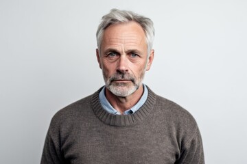 Group portrait photography of a man in his 50s appearing weakened and pale because of anemia wearing a chic cardigan against a white background 
