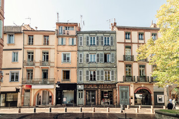 Fototapeta na wymiar Facade or exterior of historic traditional houses in the old city of Toulouse, France