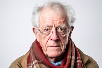 Group portrait photography of a man in his 80s with a confused and distant expression due to Alzheimer disease wearing a charming scarf against a white background 