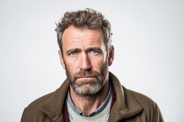 Obraz premium Lifestyle portrait photography of a man in his 40s with a pained and tired expression due to fibromyalgia wearing a chic cardigan against a white background 