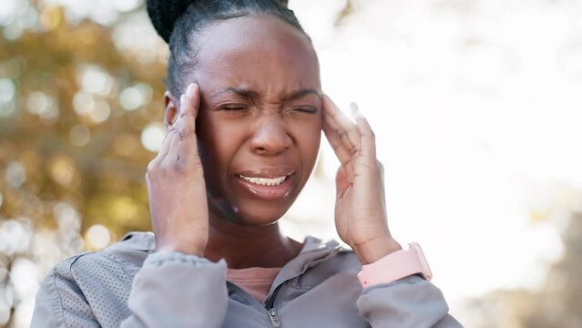 Black woman, headache and pain with fitness in park, brain fog and massage temple, health and wellness. Runner outdoor, medical emergency and migraine with stress, challenge and exercise in nature
