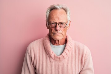 Obraz premium Medium shot portrait photography of a man in his 50s with a pained and tired expression due to fibromyalgia wearing a chic cardigan against a pastel or soft colors background 