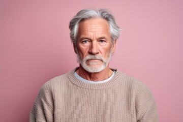 Medium shot portrait photography of a man in his 50s with a hint of fatigue due to chronic kidney disease wearing a cozy sweater against a pastel or soft colors background 