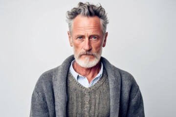 Obraz premium Medium shot portrait photography of a man in his 50s appearing tired and down due to hypothyroidism wearing a chic cardigan against a white background 