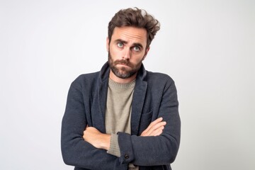 Fototapeta premium Medium shot portrait photography of a man in his 30s showing tiredness and a worn-down expression due to chronic fatigue syndrome wearing a chic cardigan against a white background 