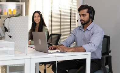 Male customer service operator wear headset working at call center office help people in...