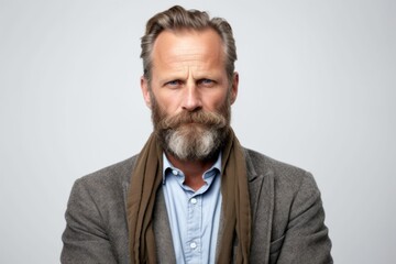 Fototapeta premium Group portrait photography of a man in his 40s showing tiredness and a worn-down expression due to chronic fatigue syndrome wearing a chic cardigan against a white background 