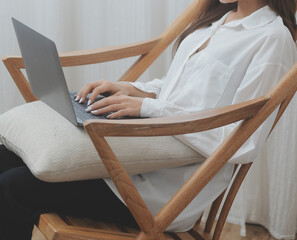 Happy freelance asian woman work on tablet on the hotel bed on travel trip. © ARMMY PICCA