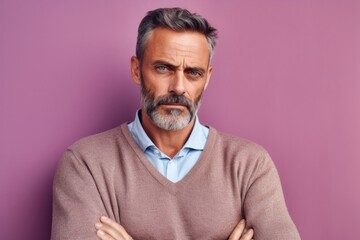 Obraz premium Lifestyle portrait photography of a man in his 40s showing tiredness and a worn-down expression due to chronic fatigue syndrome wearing a chic cardigan against a pastel or soft colors background 