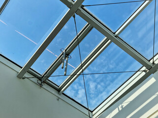 shading of the glazed ceiling of the atrium of the building. blinds under the skylight protect the...