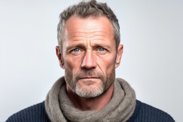 Obraz premium Close-up portrait photography of a man in his 40s with a somber and deeply sad expression due to major depression wearing a chic cardigan against a white background 