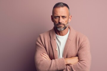 Fototapeta premium Medium shot portrait photography of a man in his 40s with a somber and deeply sad expression due to major depression wearing a chic cardigan against a pastel or soft colors background 
