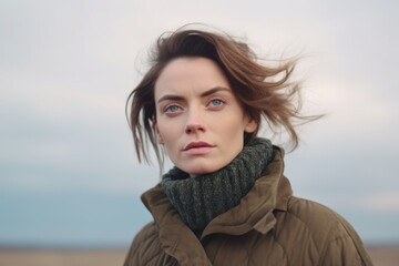 Fototapeta premium Medium shot portrait photography of a woman in her 30s with a somber and deeply sad expression due to major depression wearing a chic cardigan against a sky background 