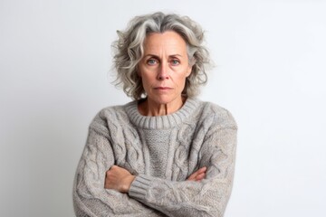 Medium shot portrait photography of a woman in her 50s looking anxious and fidgety due to generalized anxiety disorder wearing a cozy sweater against a white background  - obrazy, fototapety, plakaty