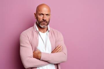 Medium shot portrait photography of a man in his 40s looking anxious and fidgety due to generalized anxiety disorder wearing a chic cardigan against a pastel or soft colors background 