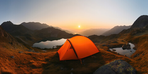 Orange tourist tent in mountains over Mountain Lake