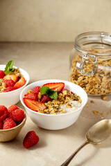 Oatmeal porridge with strawberry, homemade granola. Healthy breakfast.