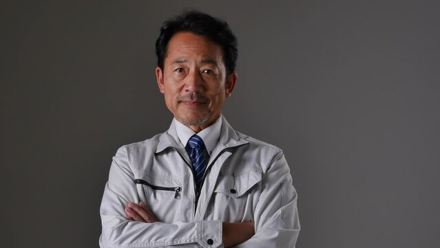ミドルエイジの作業員　黒背景　カメラ目線
