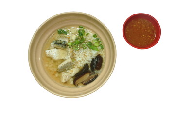 boiled rice with slice bass fish topping chop spring onion and fried garlic in clear soup on bowl dipping spicy chili sauce 