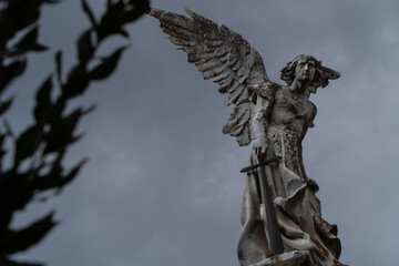 Ancient victorian statue of Destroyer Angel at a graveyard with dark sky. Artist: Josep Limona...