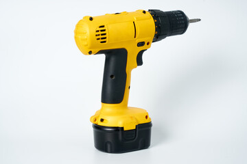 Black and yellow cordless drill on a white isolated background.