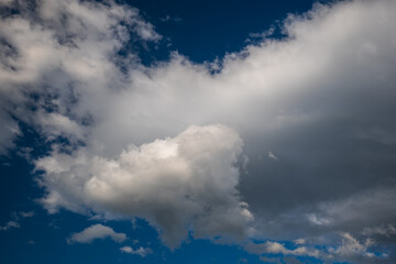 Beautifully puffy summer clouds against blue sky background, taken witha  polarized lens.