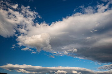 Beautifully puffy summer clouds against blue sky background, taken witha  polarized lens.