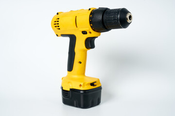 Black and yellow cordless drill on a white isolated background.