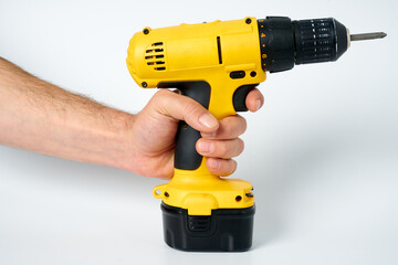 Black and yellow cordless drill on a white isolated background.