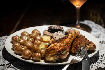 Seasoned crispy baked chicken dinner with wine.