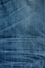 blue denim background with a seam. light blue color denim jeans fabric texture. copy space for text