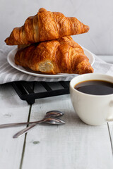 A cup of coffee and croissants. on white wooden. breakfast. Morning