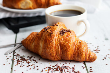A cup of coffee and croissants. on white wooden. breakfast. Morning