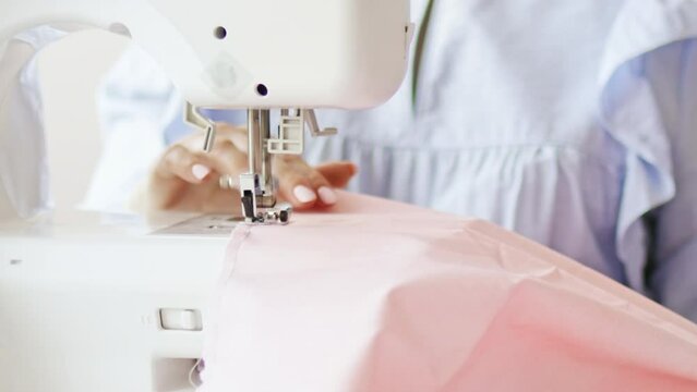 Woman clothing designer sews fabrics on a sewing machine. Needlework and handmade patchwork hobby.	