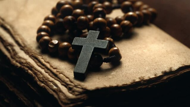 Holy Bible and wooden cross on the desk. Spirituality religion and hope concept. Symbol of supplication believe and faith for Christian People. Abstract vintage historical religious dark background