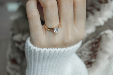 Close up of diamond ring on woman&rsquo;s finger. Love, valentine, relationship and wedding concept. Soft and selective focus.