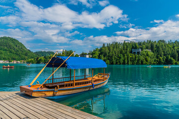 A view past a  Pletna boat moored on Bled island in Bled, Slovenia in summertime