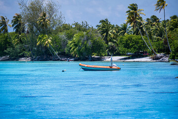 Fototapeta na wymiar Small Boat Tied -up in Beautiful Blue Water