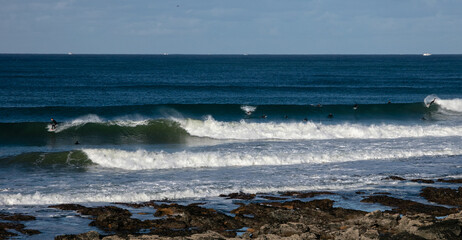 Surfers enjoying the magnificent waves at Supertubes, Jeffreys Bay.