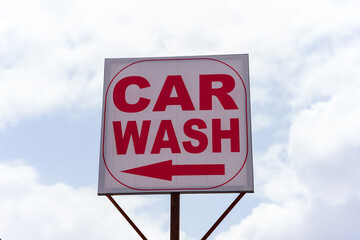 car wash sign board with sky in background