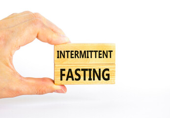 Intermittent fasting symbol. Concept words Intermittent fasting on beautiful wooden block. Beautiful white table white background. Healthy lifestyle intermittent fasting concept. Copy space.