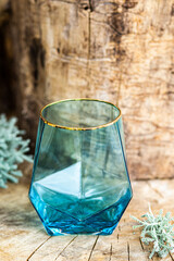blue glass cup on wooden background 